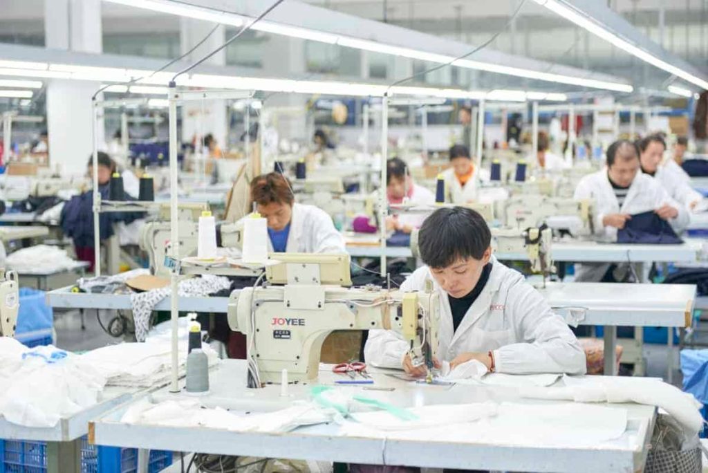 Sewing operators working at machines in Hengcheng garment factory