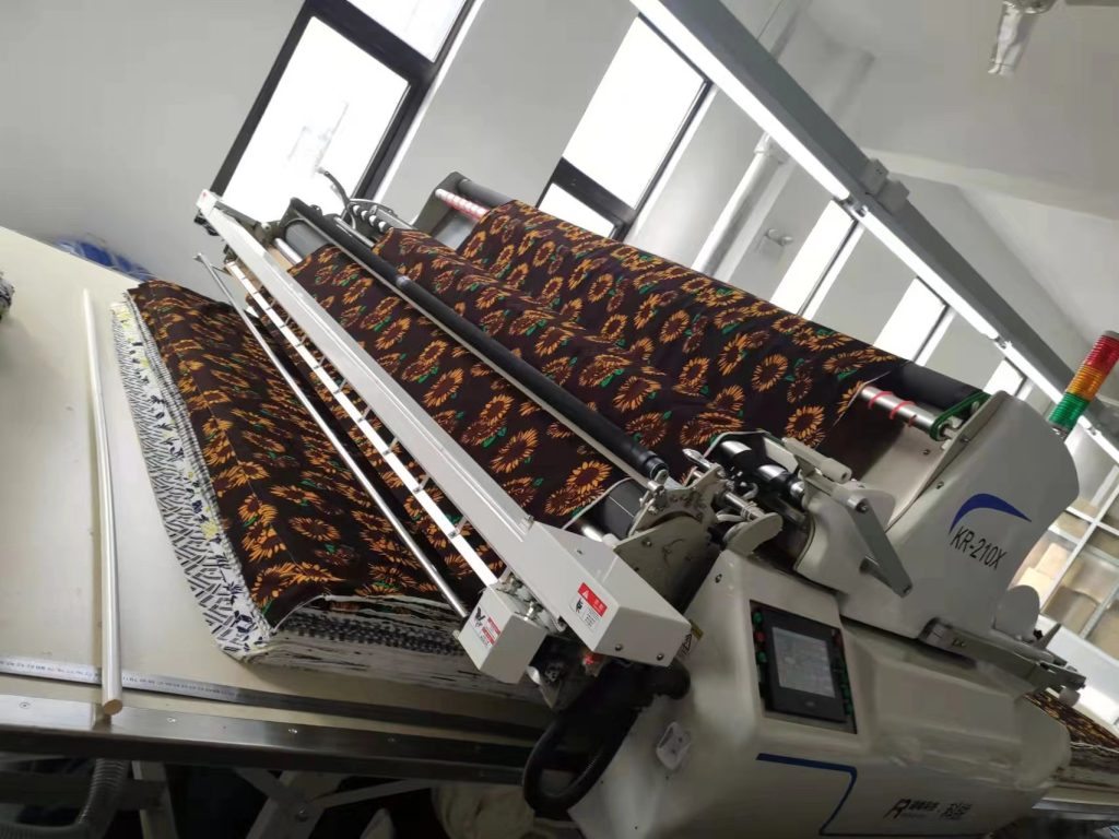 Fabric inspection machine checking printed textile before garment production