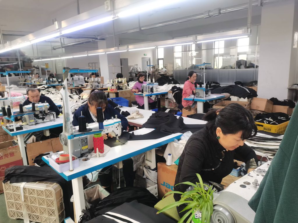 Garment sewing workshop assembling black and white apparel