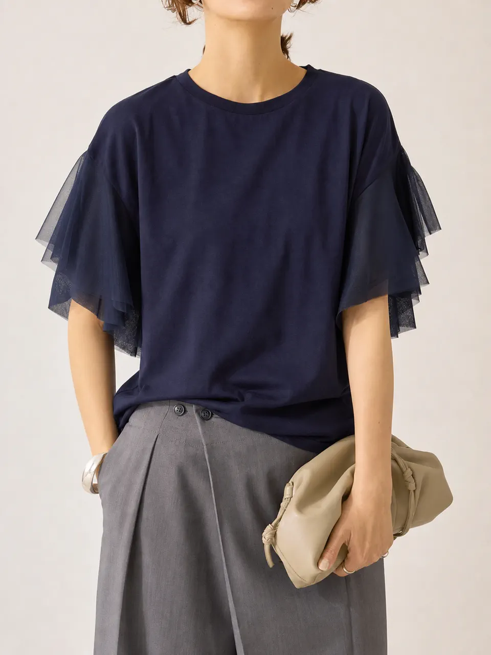 透け感のあるレイヤード袖を合わせたネイビーのリラックスフィットTシャツ。レディースブランド別注の参考