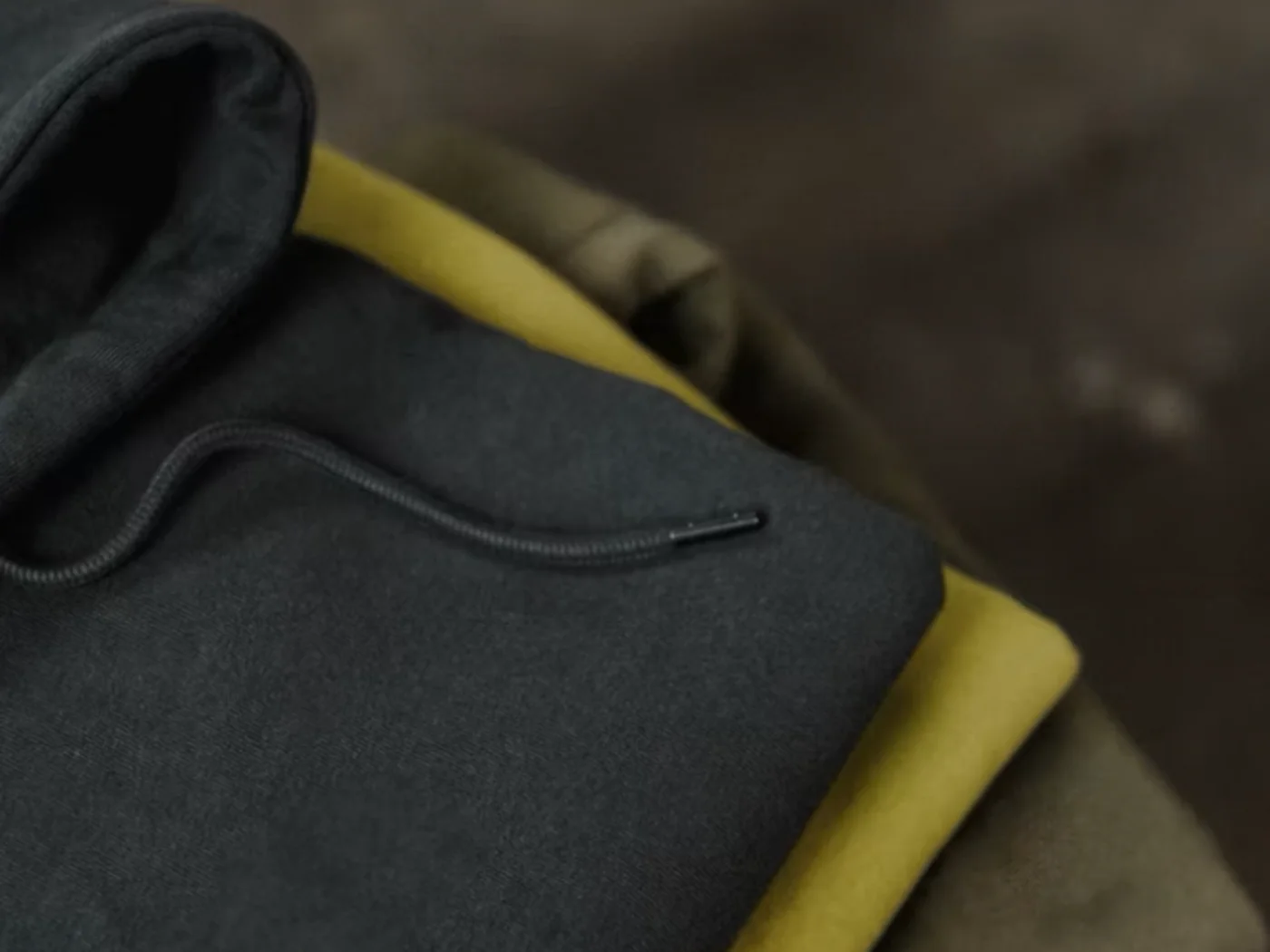 Folded hoodie samples showing fleece color options for low-MOQ planning