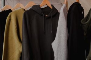 Colorful hoodie collection on display rack showing finished garment quality