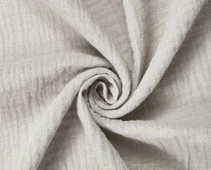 Natural cotton muslin fabric close-up for breathable private-label sleepwear and pajama development