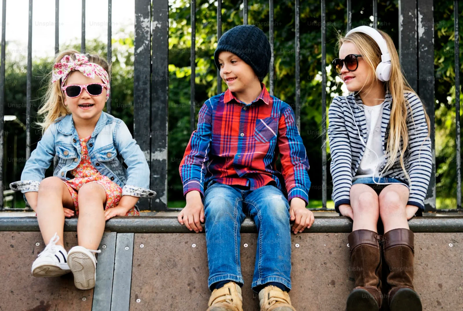 Three children wearing casual apparel outdoors for kidswear product development